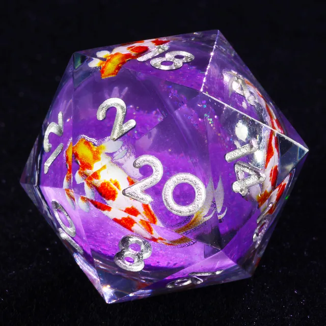 Close-up of clear D20 with purple core, orange-and-white fish imagery and silver numerals.