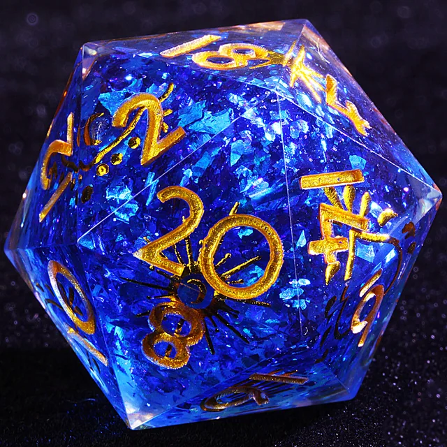 Close-up of a translucent blue D20 with shimmering flecks and gold numbers.