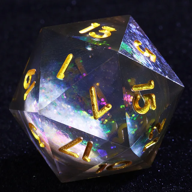 Close-up of a clear, sharp-edged D20 with gold numbers and a multicoloured glitter core.