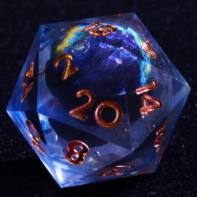 Close-up of a clear D20 with a blue-green globe core and copper-gold numbers.
