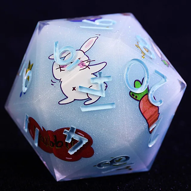 Close-up of a pale blue polyhedral die with a white rabbit, carrot, shimmer and light-blue numbers.
