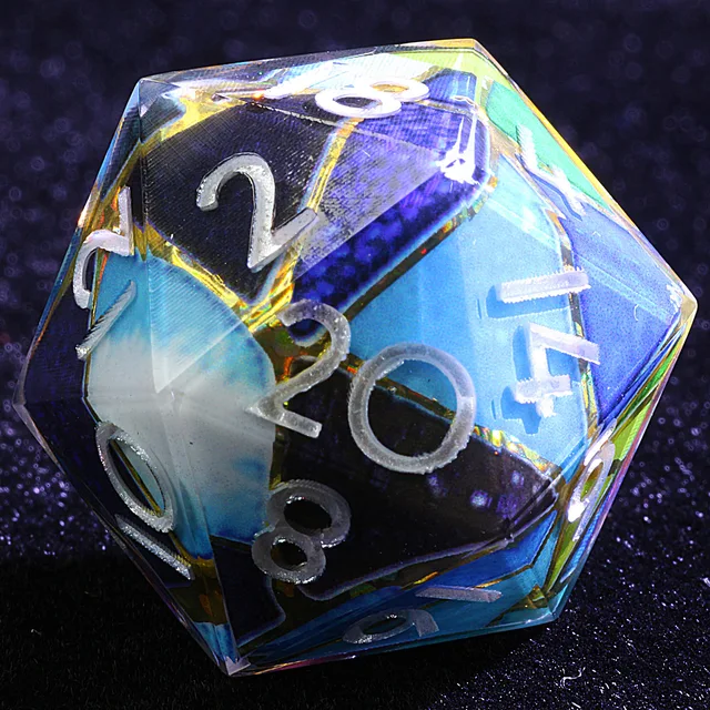 Close-up of a D20 with blue, green and dark shard-like panels, gold-toned lines and silver-white numbers.