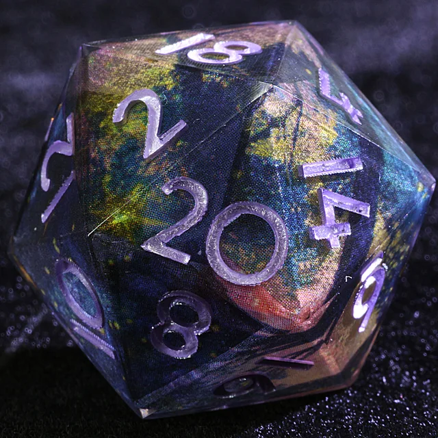 Close-up of a dark blue and purple D20 with teal and gold nebula-like patches and pale lavender numbers.
