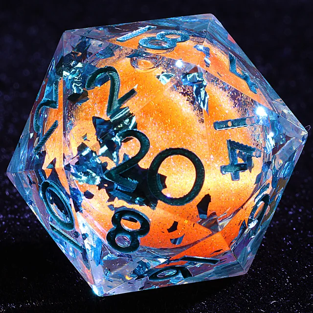 Close-up of a clear D20 with blue reflective flakes, an orange core and dark numerals.