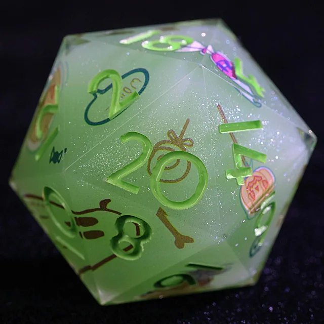 Close-up of a translucent pale green glittery D20 with bright green numerals and candy illustrations.