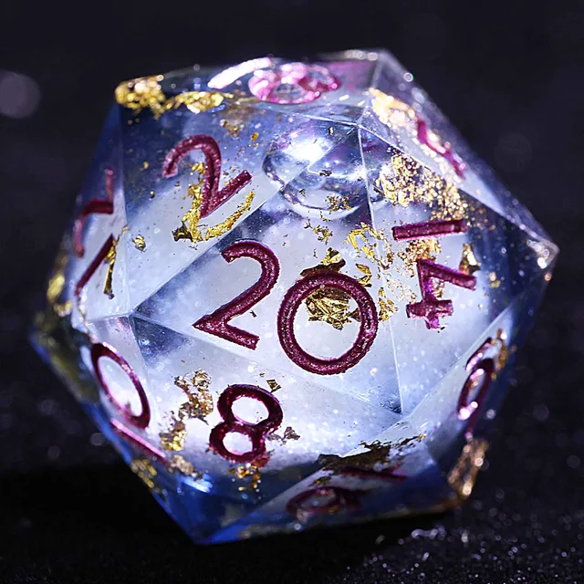 Close-up of a blue-tinted liquid-core D20 with gold-coloured flecks and magenta numbers.