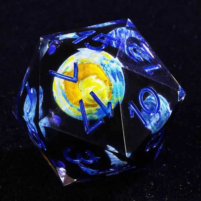 Close-up of black D20 with blue numbers and a yellow-centered blue and white swirl.