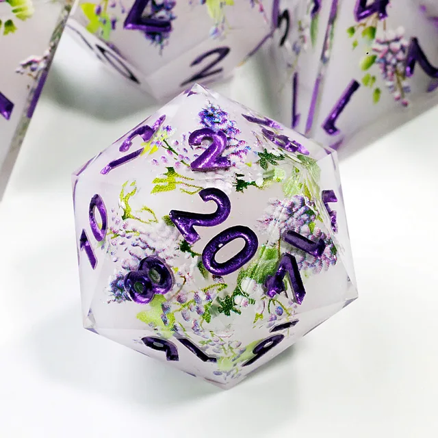 Close-up of a clear floral D20 with purple numbers.