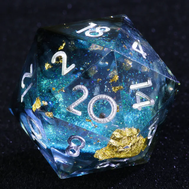 Close-up of a transparent blue liquid-core D20 with gold-coloured flakes and silver-coloured numbers.