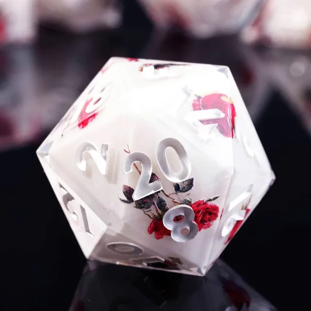 Close-up of a rose-patterned D20 with white numerals.
