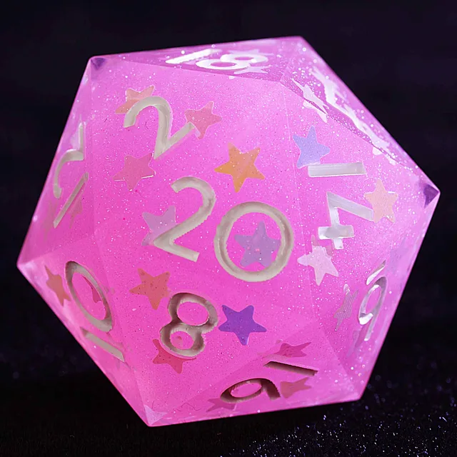 Close-up of a pink glittery D20 with multicoloured stars and pale numbers.