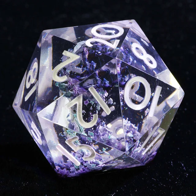 Close-up of a clear D20 with violet and blue inclusions and white numerals.