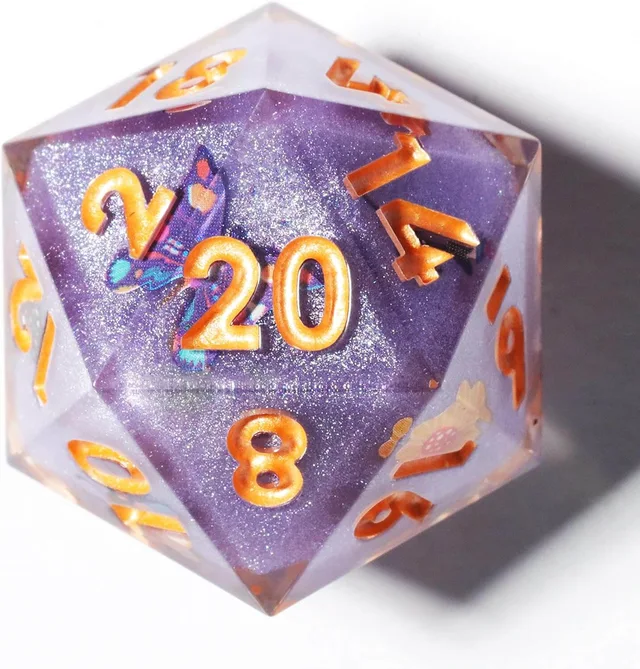 Close-up of a purple glitter D20 with a butterfly and gold-orange numbers.