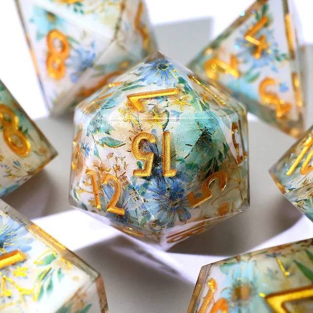 Close-up of the blue floral D20 with gold numbers.