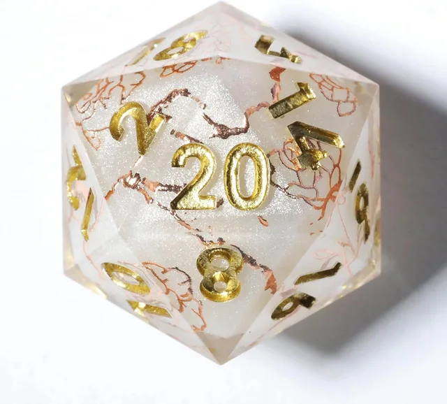 Close-up of a pearly white D20 with gold numbers and rose-gold floral linework.