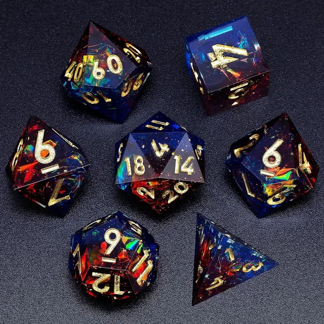 Seven sharp-edged blue and red translucent dice with iridescent flecks and gold numbers on a dark surface.