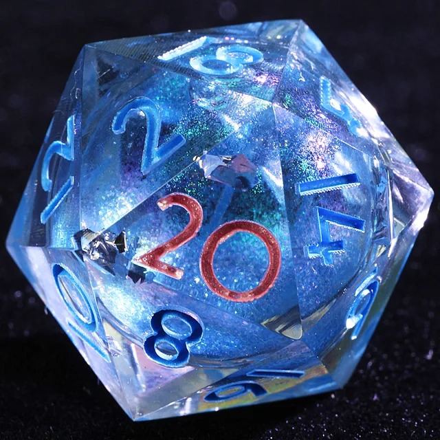 Close-up of a clear D20 with a sparkling blue core and contrasting numerals.