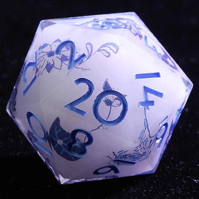 Close-up of a pale lavender-white D20 with blue numbers and floral patterns.
