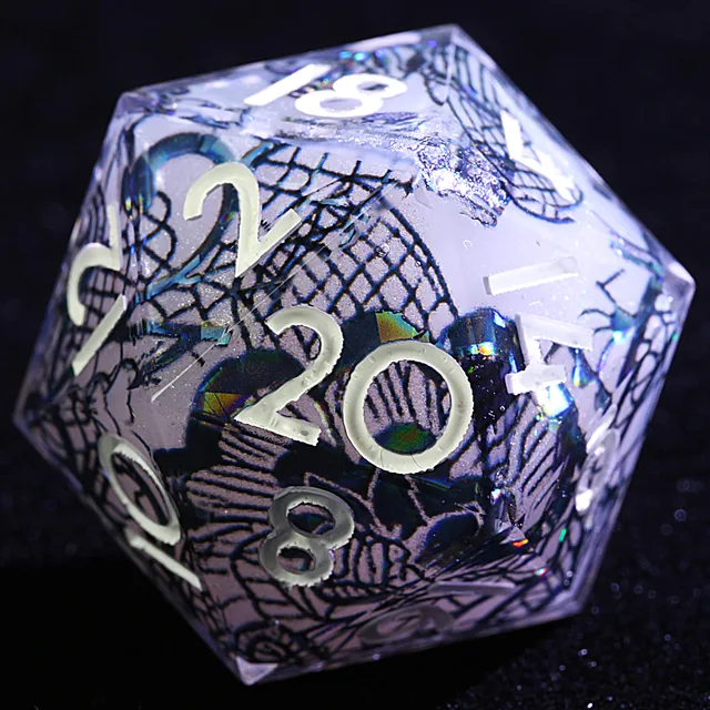 Close-up of the patterned translucent D20 with pale numbers and iridescent details.