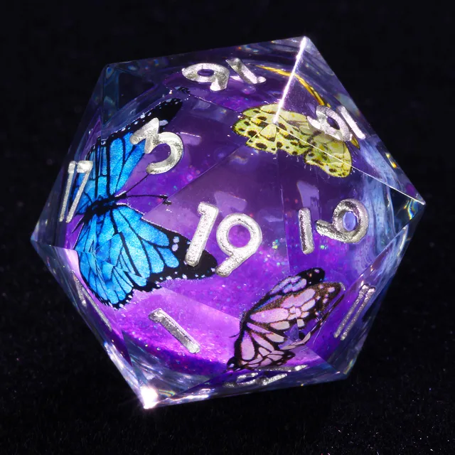 Close-up of a clear purple-core D20 with silver numbers and blue, yellow and pink butterflies.