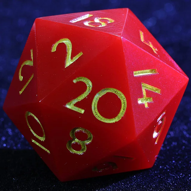 Close-up of a crimson-red D20 with gold numbers.