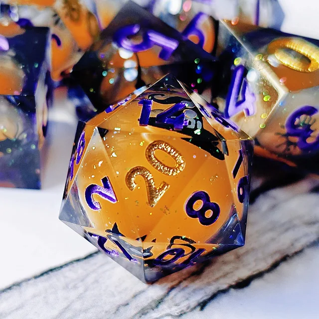 Close-up of a purple-numbered D20 with an orange core and glitter flecks.