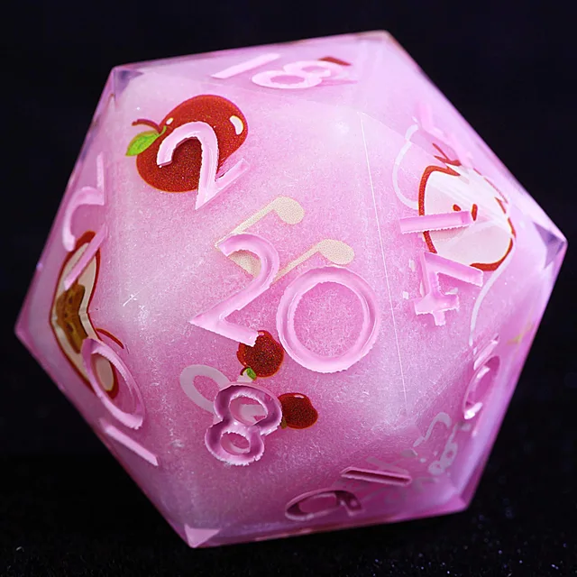 Close-up of a pink twenty-sided die with pale numerals and red apple designs.