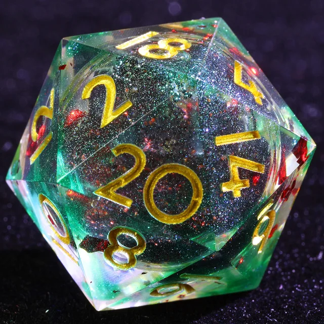 Close-up of a teal-green glittery D20 with a dark core, red flecks and gold numbers.