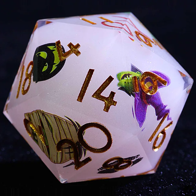 Close-up of a pearl-white Halloween die with gold numbers, a witch and other spooky illustrations.