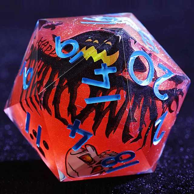 Close-up of a glittering crimson D20 with blue numbers and a black jack-o'-lantern design.