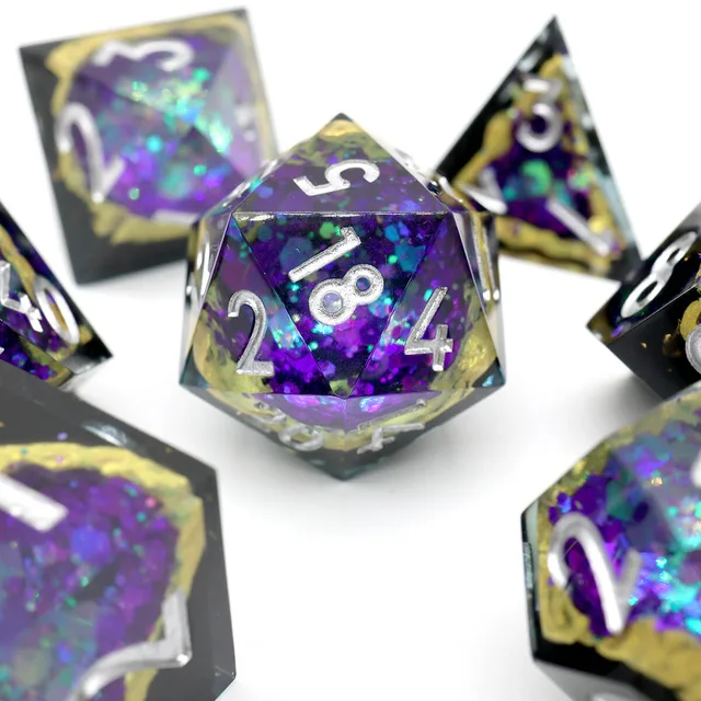Close-up of a purple geode-pattern D20 with silver numbers.