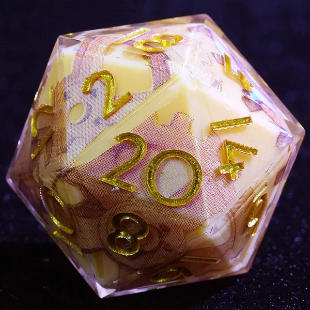 Close-up of a clear-edged D20 with a cream interior, brown pattern and gold numbers.