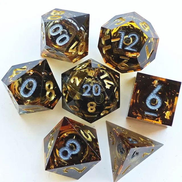Seven translucent amber and smoky dice with gold flecks and silver and gold numbers on white.