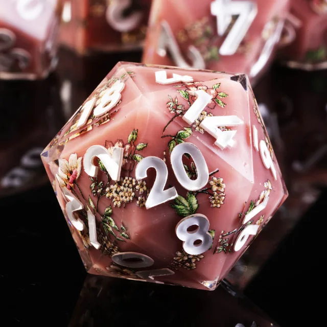 Close-up of a pink floral D20 with white numerals