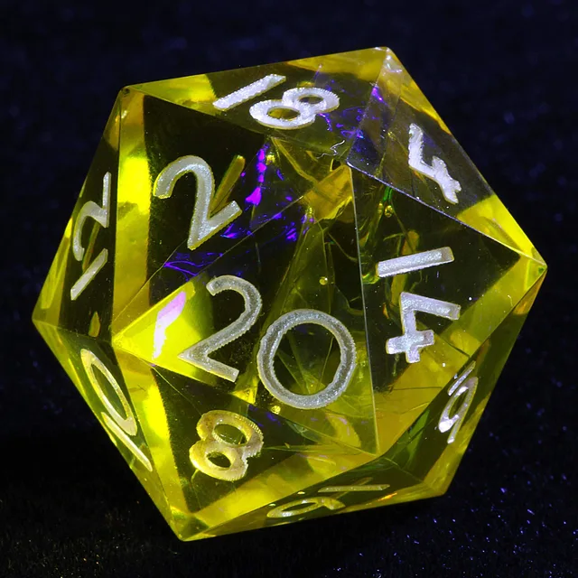 Close-up of a translucent yellow D20 with pale numerals and iridescent interior.