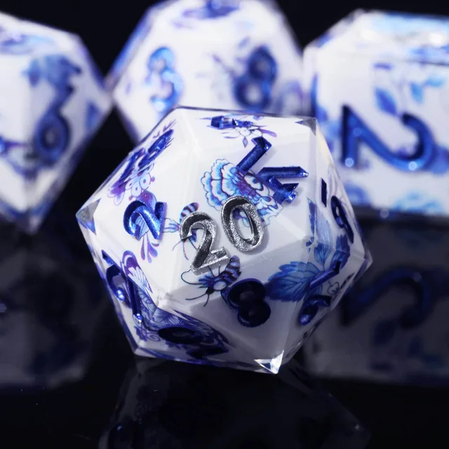 Close-up of a blue floral D20 with raised numerals and clear edges