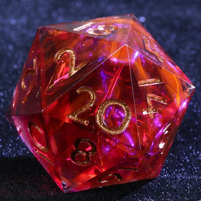 Close-up of a translucent crimson D20 with orange wisps and gold-coloured numerals.