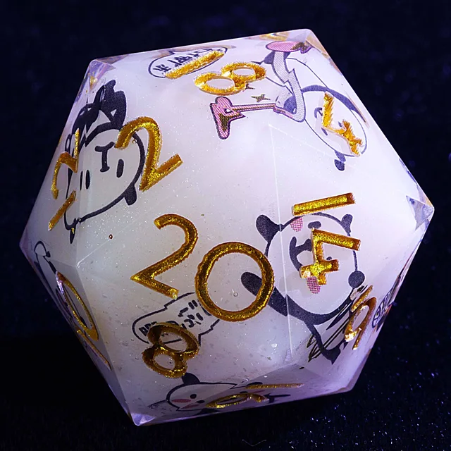 Close-up of a milky-white D20 with cartoon pandas and gold numbers.