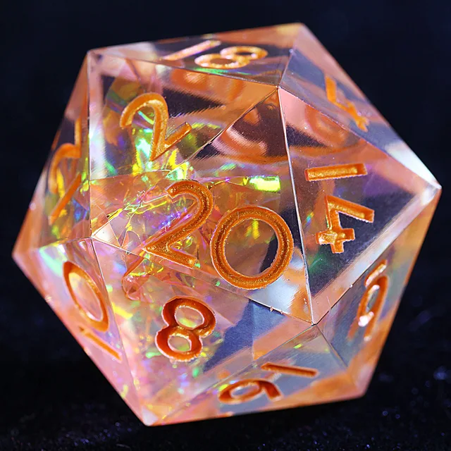 Close-up of a transparent peach-orange D20 with iridescent fragments and orange-gold numerals.