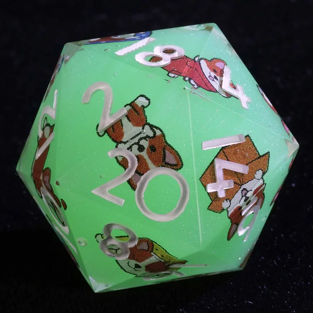 Close-up of a mint-green glitter D20 with white numbers and corgi illustrations.