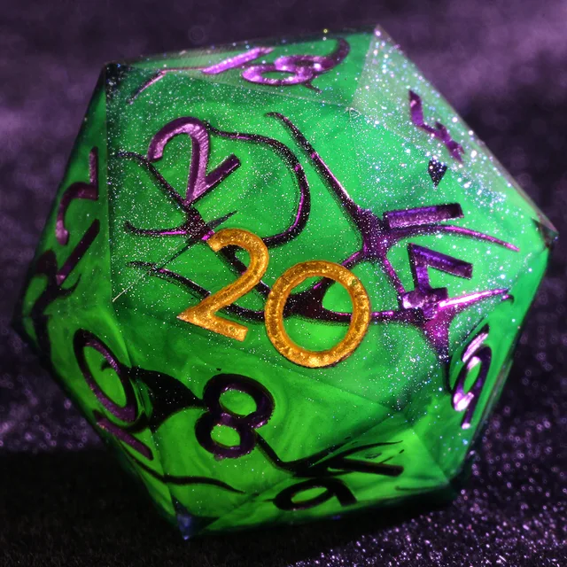 Close-up of a green glittery D20 with purple vine-like patterns and a gold 20.