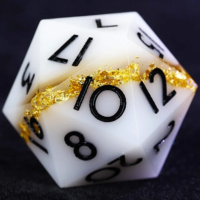 Close-up of a white D20 with a gold-foil band and black numerals.
