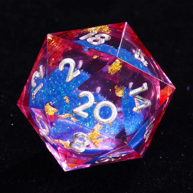 Close-up of a silver-numbered D20 with red-pink transparent edges, blue glittering centre and gold-coloured flakes.