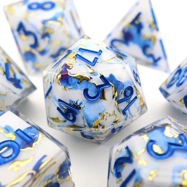 Close-up of a multifaceted blue, white and gold die.