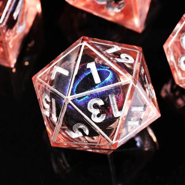 Close-up of a red translucent D20 with silver numbers and a shimmering blue-purple centre.