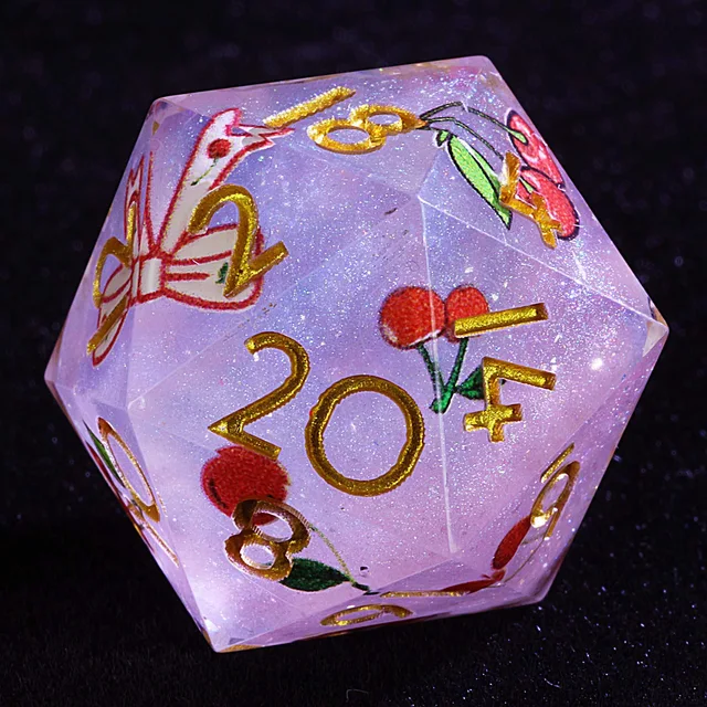 Close-up of a pale lavender glitter D20 with gold numbers and red cherry illustrations.