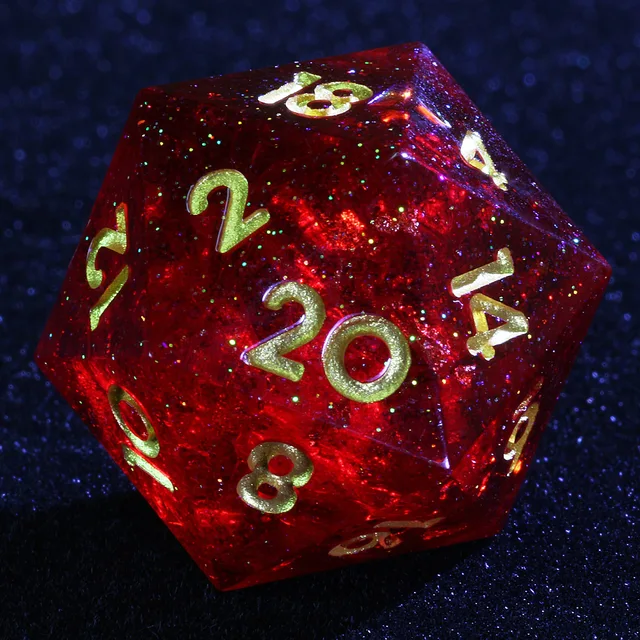 Close-up of a translucent glittery red D20 with gold-coloured numbers.