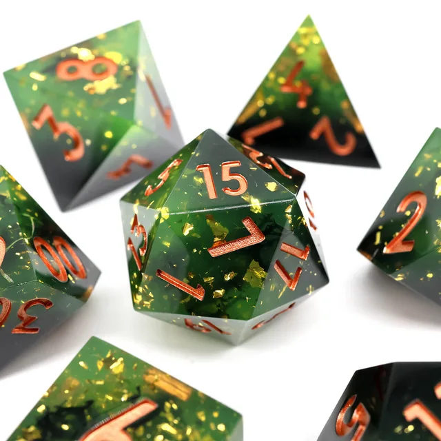 Close-up of the green and dark D20 with gold-coloured flecks and copper-coloured numbers.