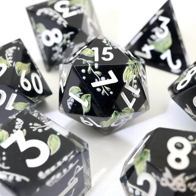 Close-up of a black botanical D20 with white numbers.