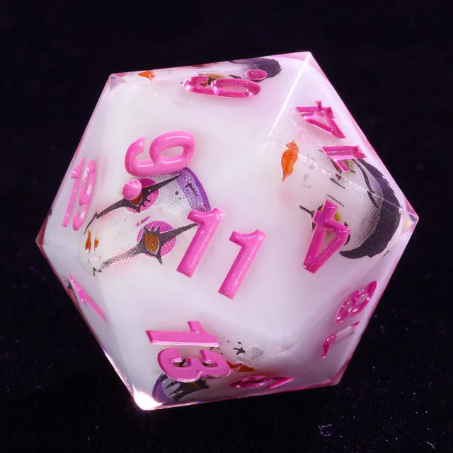 Close-up of white D20 with pink numbers and clown-face illustrations.